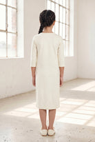 Model wearing Nuggles® Girls Midi Layering Dress in Cream