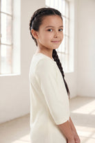 Model wearing Nuggles® Girls Midi Layering Dress in Cream