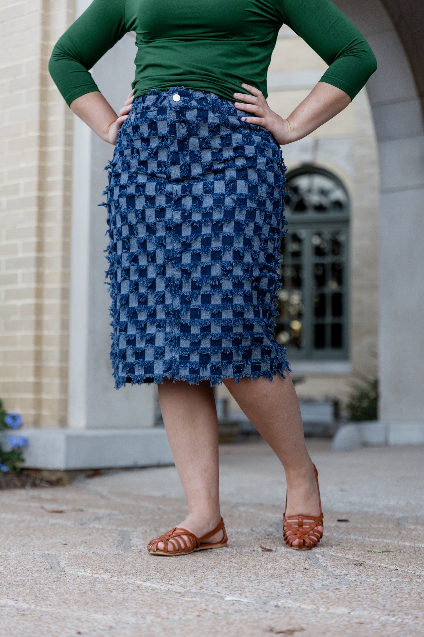 Nuggles® denim midi skirt with soft stretch fabric, wide elastic waistband, modest length, and functional pockets. Available in 27", 31", and 34" lengths.