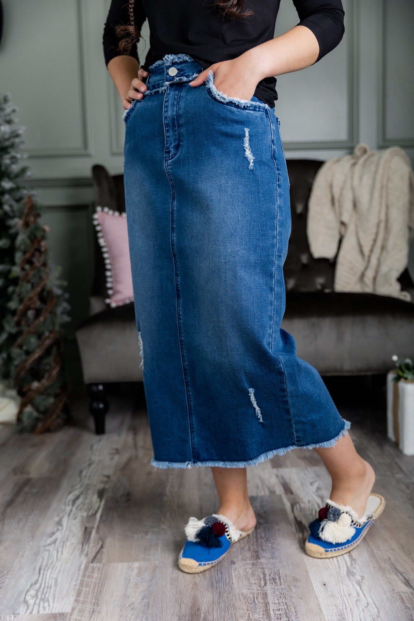 Nuggles® denim midi skirt with soft stretch fabric, wide elastic waistband, modest length, and functional pockets. Available in 27", 31", and 34" lengths.