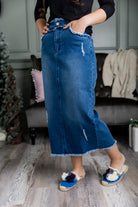 Nuggles® denim midi skirt with soft stretch fabric, wide elastic waistband, modest length, and functional pockets. Available in 27", 31", and 34" lengths.