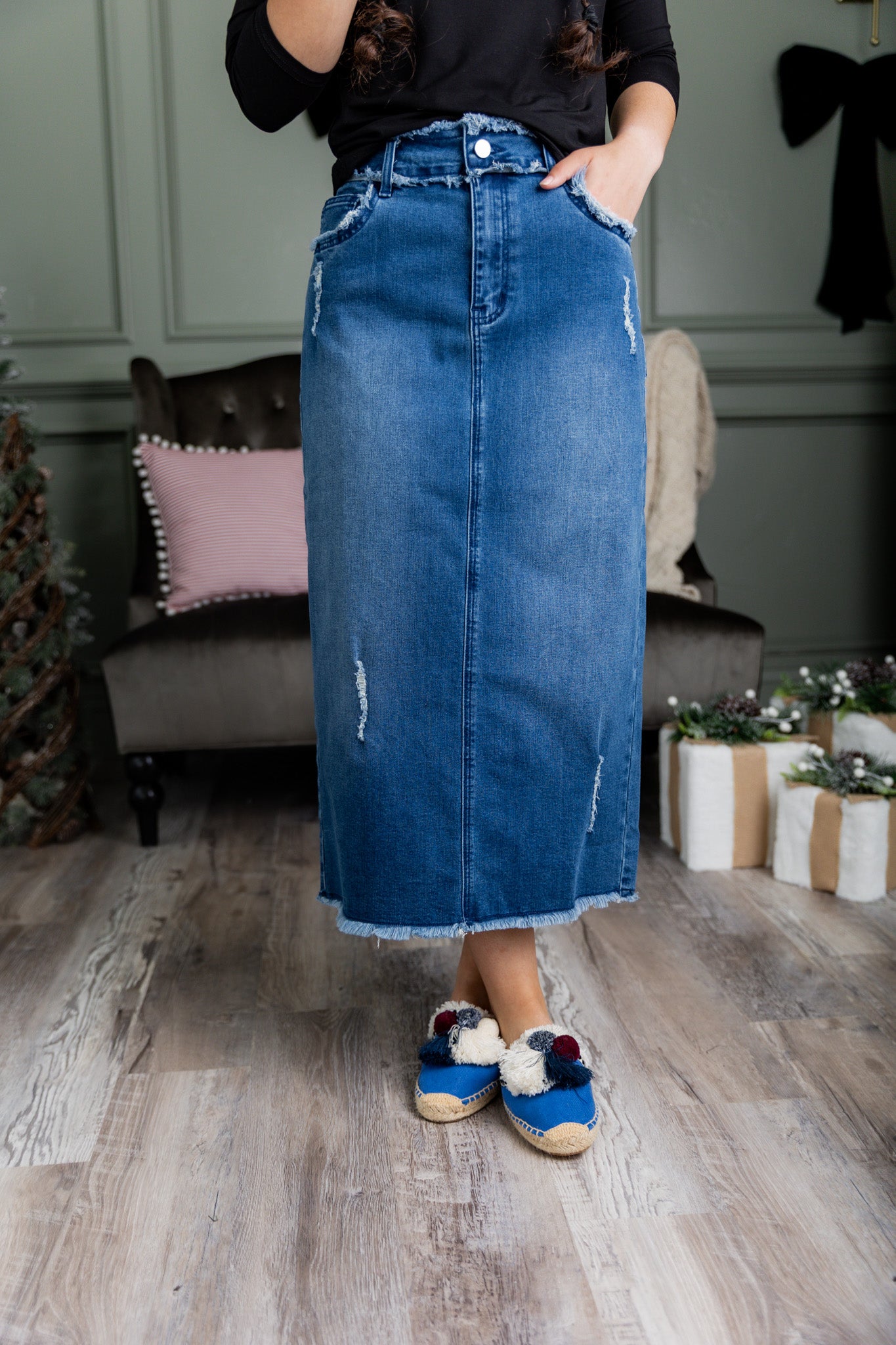 Nuggles® denim midi skirt with soft stretch fabric, wide elastic waistband, modest length, and functional pockets. Available in 27", 31", and 34" lengths.