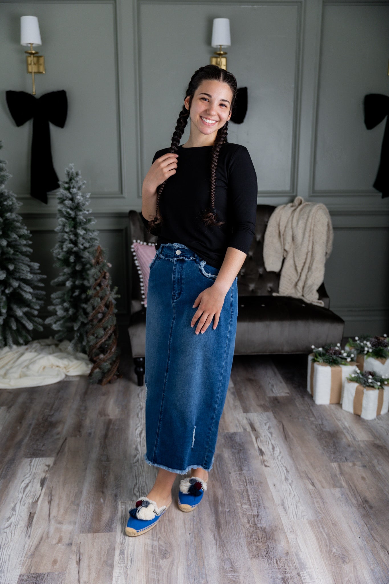 Nuggles® denim midi skirt with soft stretch fabric, wide elastic waistband, modest length, and functional pockets. Available in 27", 31", and 34" lengths.