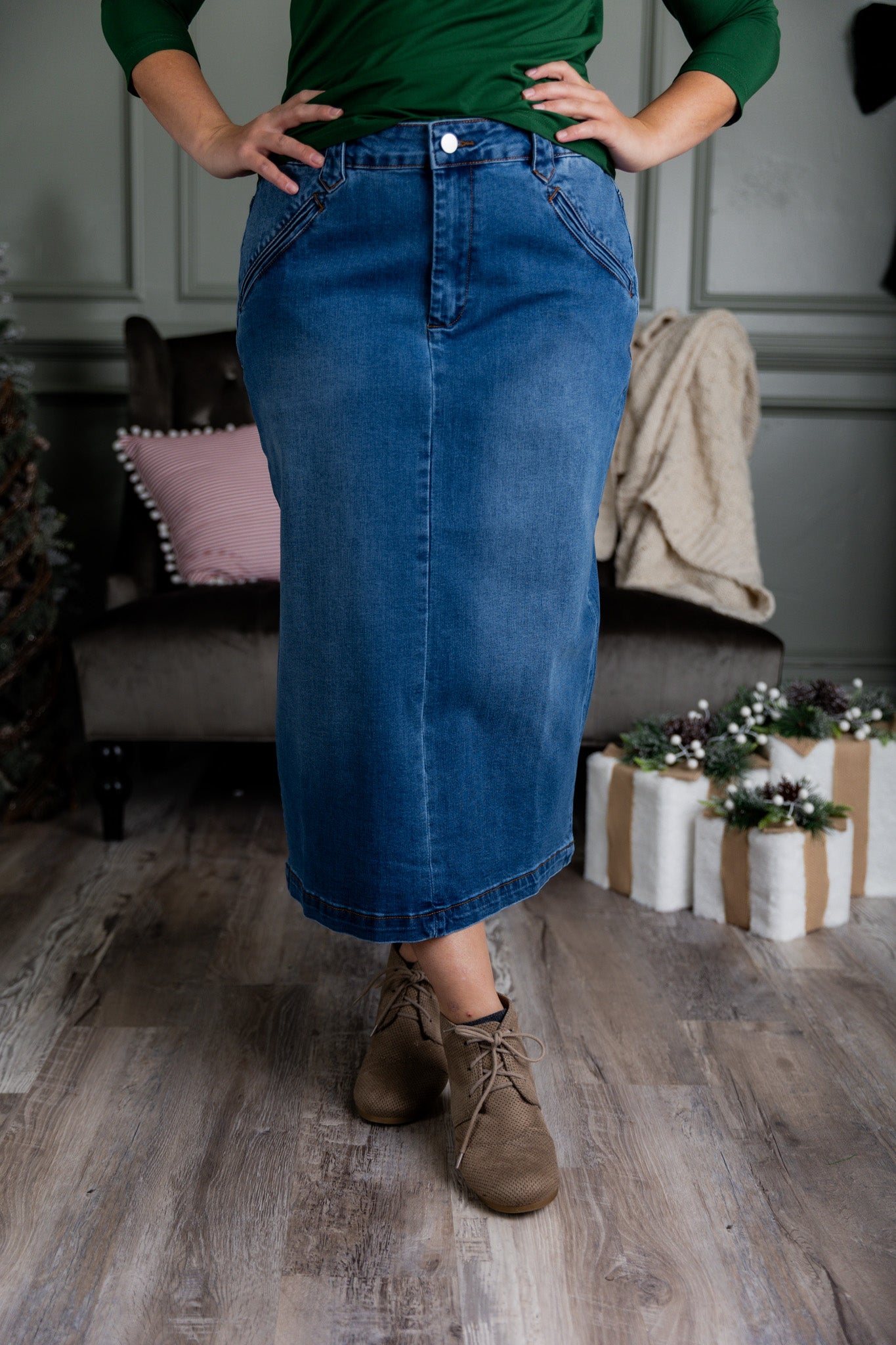 Nuggles® denim midi skirt with soft stretch fabric, wide elastic waistband, modest length, and functional pockets. Available in 27", 31", and 34" lengths.