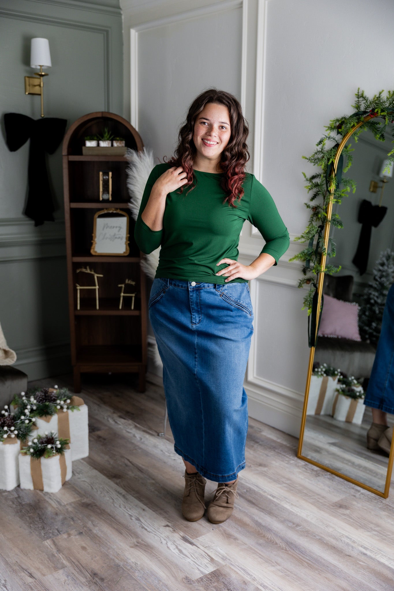 Nuggles® denim midi skirt with soft stretch fabric, wide elastic waistband, modest length, and functional pockets. Available in 27", 31", and 34" lengths.