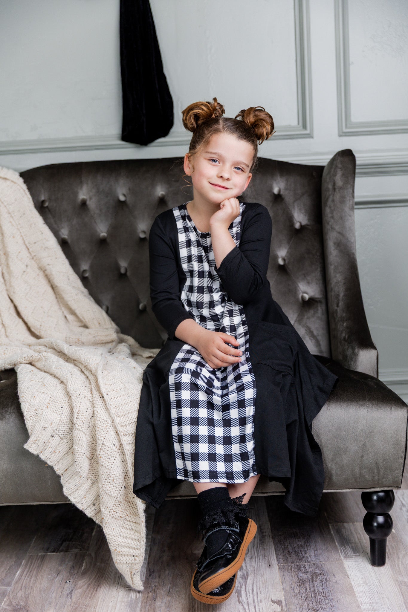 Nuggles® Raegan girls’ dress demonstrated on young model for product listing.