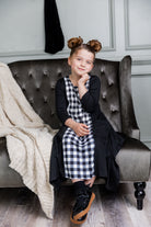 Nuggles® Raegan girls’ dress demonstrated on young model for product listing.