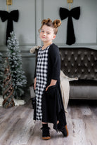 Nuggles® Raegan girls’ dress demonstrated on young model for product listing.