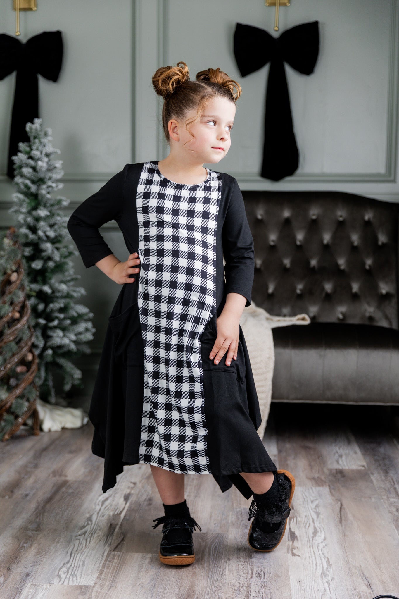 Nuggles® Raegan girls’ dress demonstrated on young model for product listing.