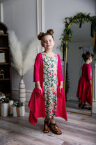 Nuggles® Raegan girls’ dress demonstrated on young model for product listing.