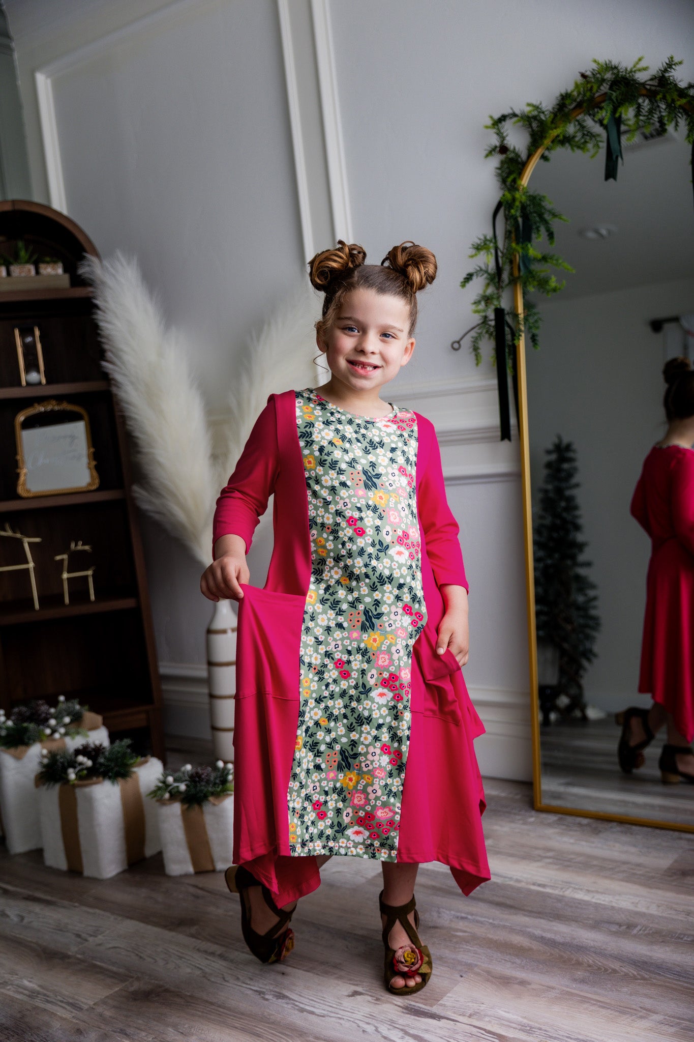 Nuggles® Raegan girls’ dress demonstrated on young model for product listing.