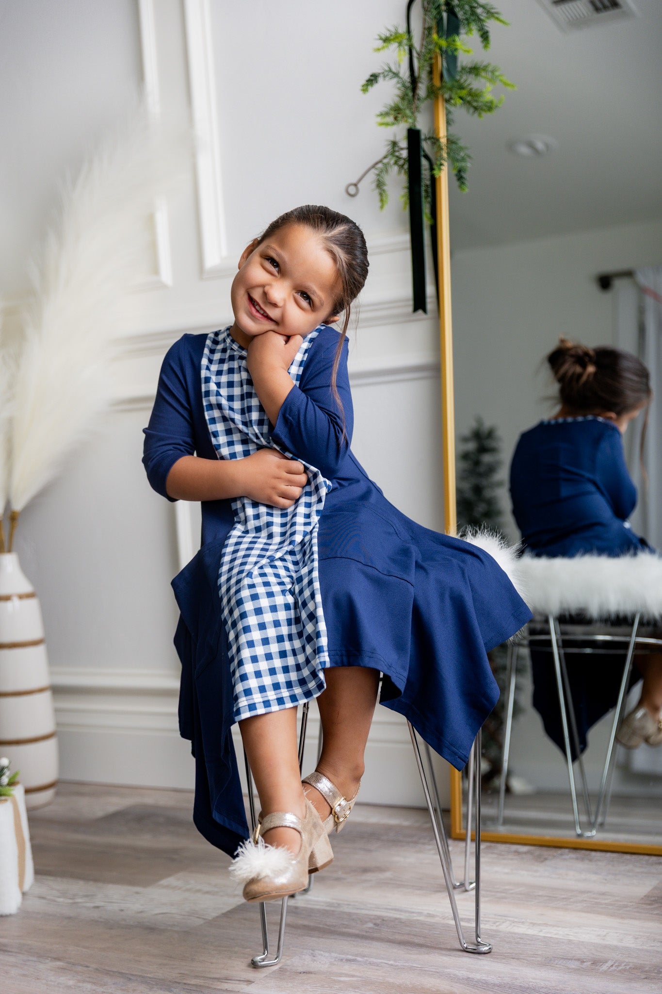 Nuggles® Raegan girls’ dress demonstrated on young model for product listing.