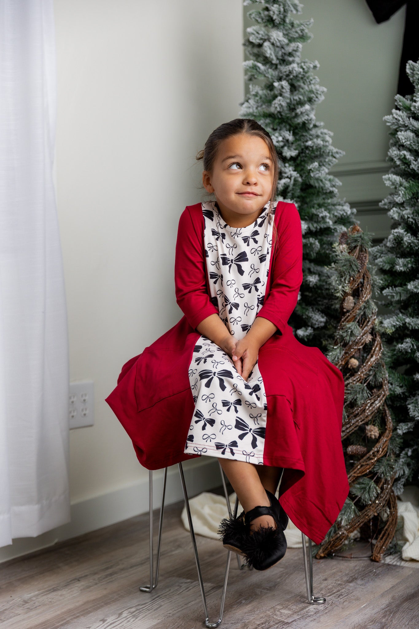 Nuggles® Raegan girls’ dress demonstrated on young model for product listing.