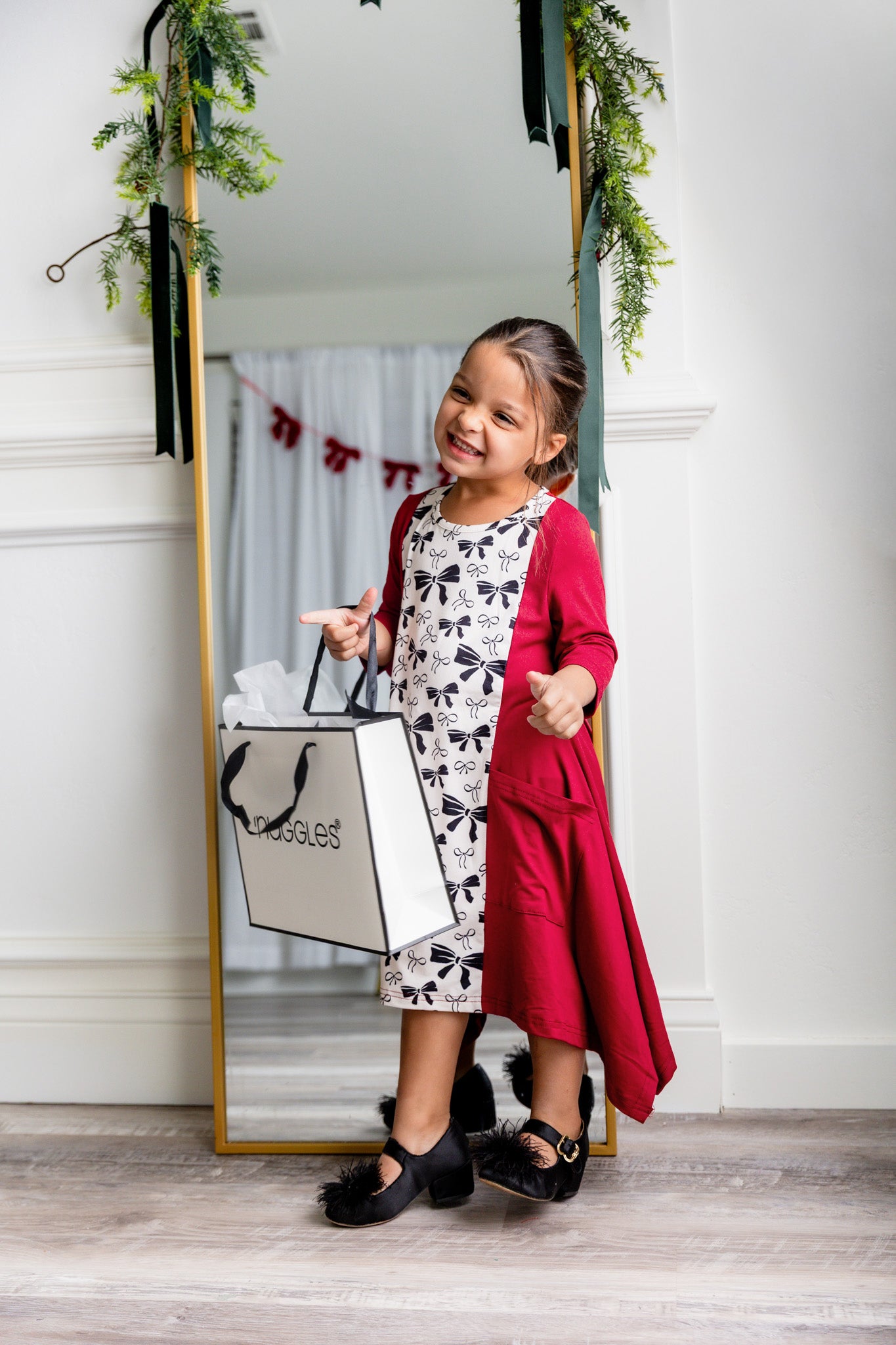 Nuggles® Raegan girls’ dress demonstrated on young model for product listing.