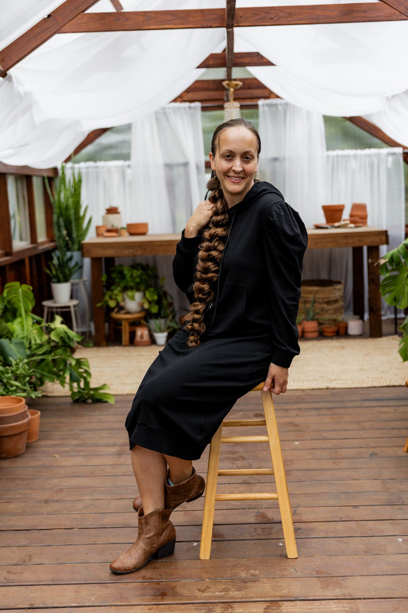 Model wearing Nuggles® Zoelle Dress in solid color, modest hoodie dress with puff sleeves.