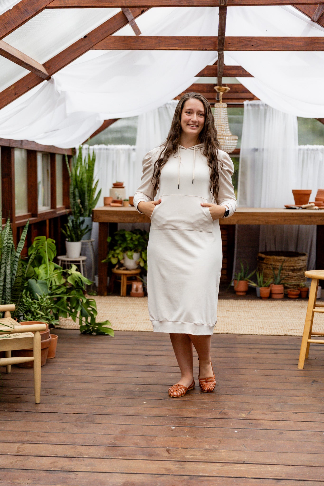 Model wearing Nuggles® Zoelle Dress in solid color, modest hoodie dress with puff sleeves.