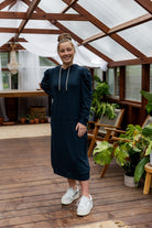 Model wearing Nuggles® Zoelle Dress in solid color, modest hoodie dress with puff sleeves.