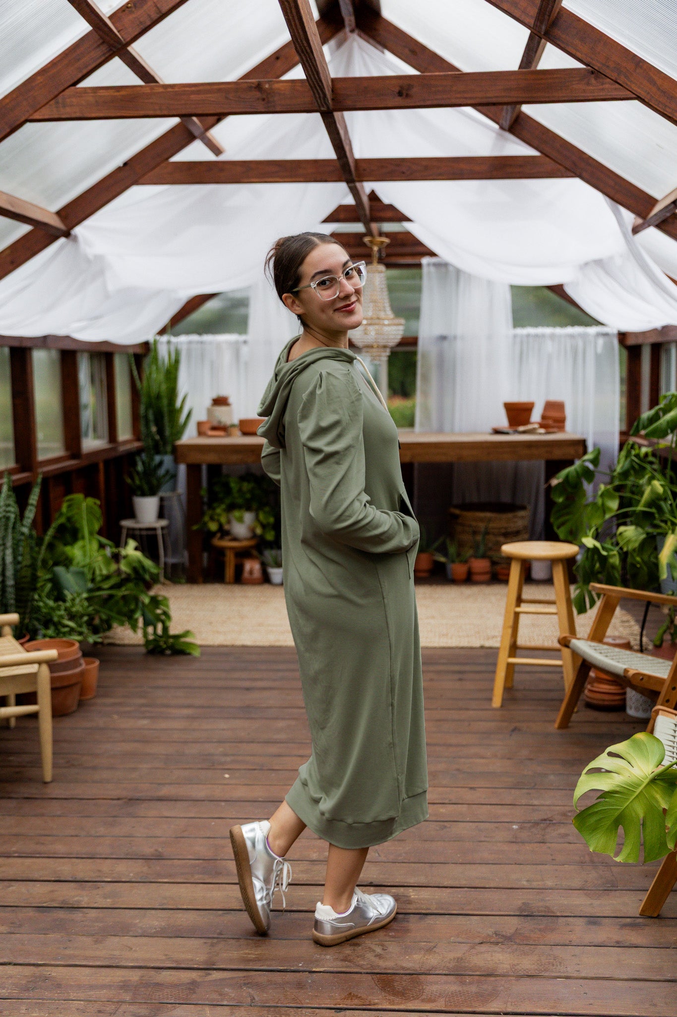 Model wearing Nuggles® Zoelle Dress in solid color, modest hoodie dress with puff sleeves.