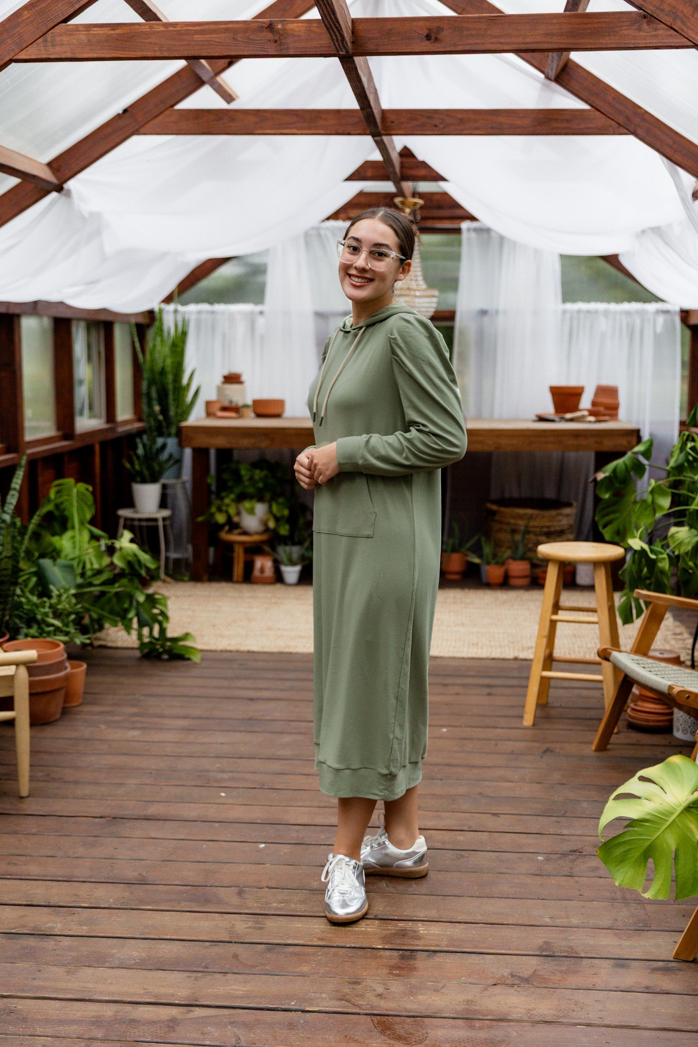 Model wearing Nuggles® Zoelle Dress in solid color, modest hoodie dress with puff sleeves.