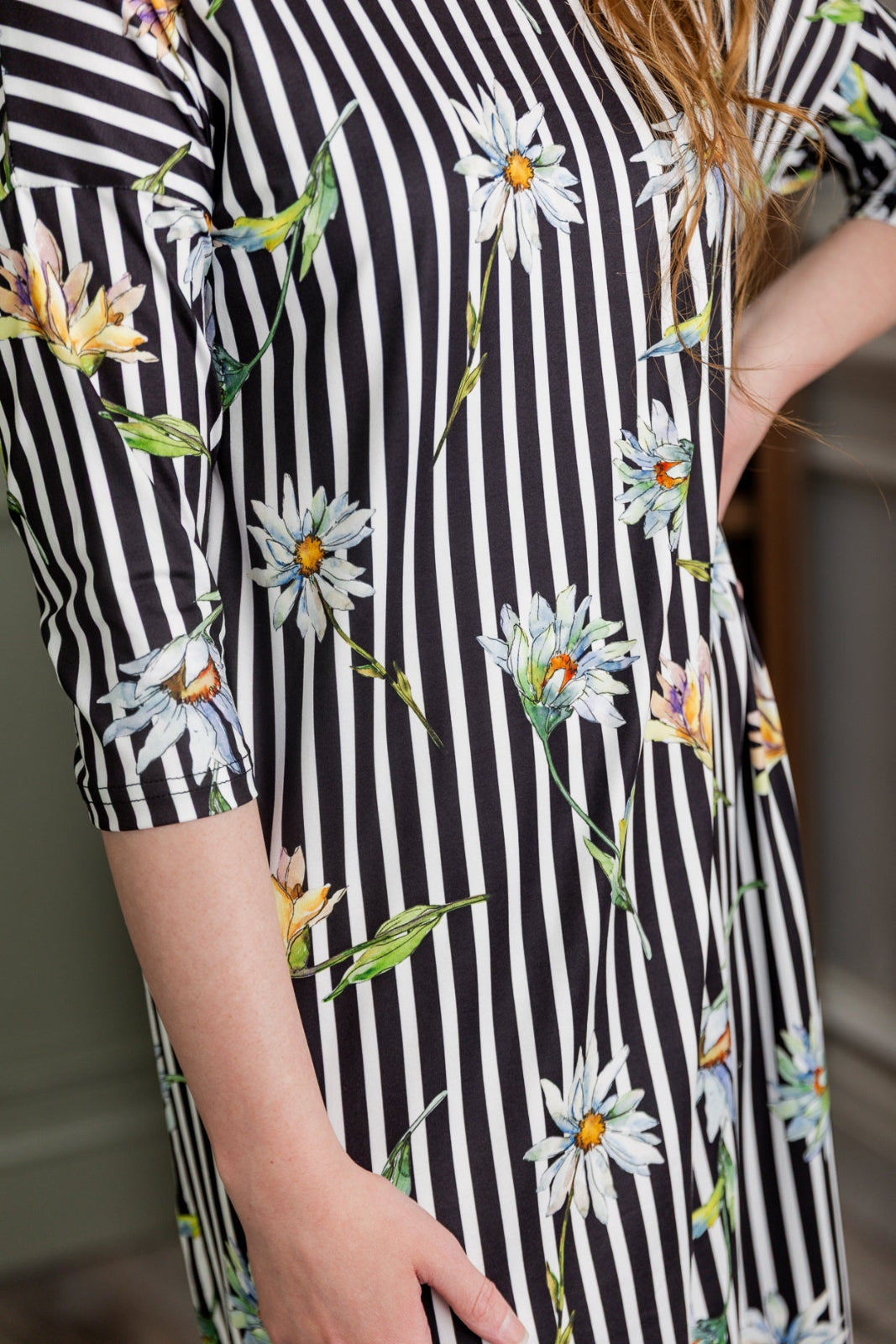 Model wearing the Nuggles® Heather Dress in Daisy Stripe