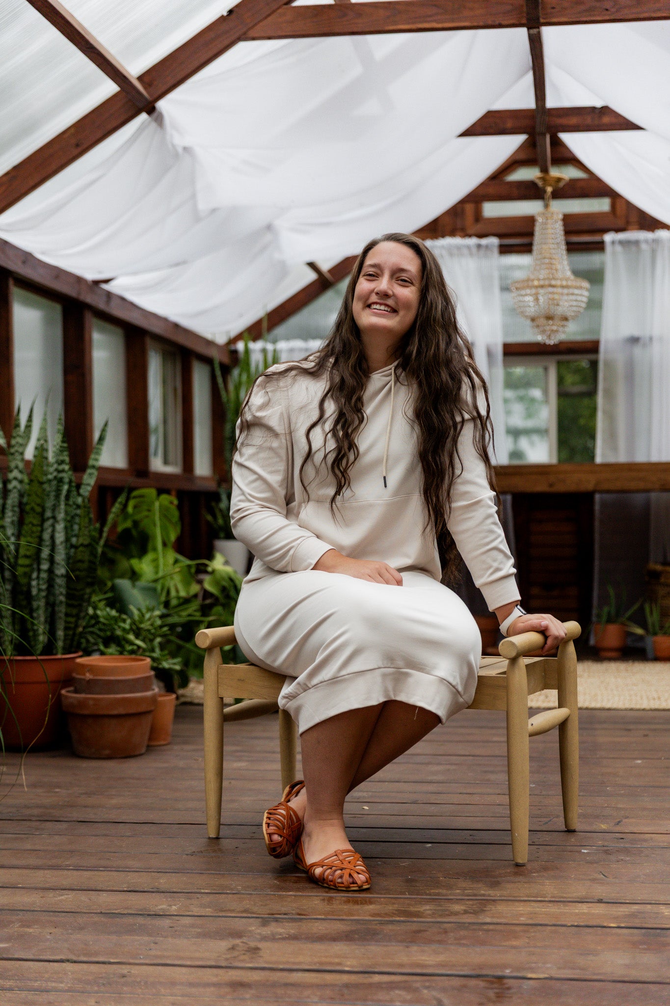 Model wearing Nuggles® Zoelle Dress in solid color, modest hoodie dress with puff sleeves.