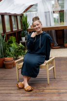 Model wearing Nuggles® Zoelle Dress in solid color, modest hoodie dress with puff sleeves.