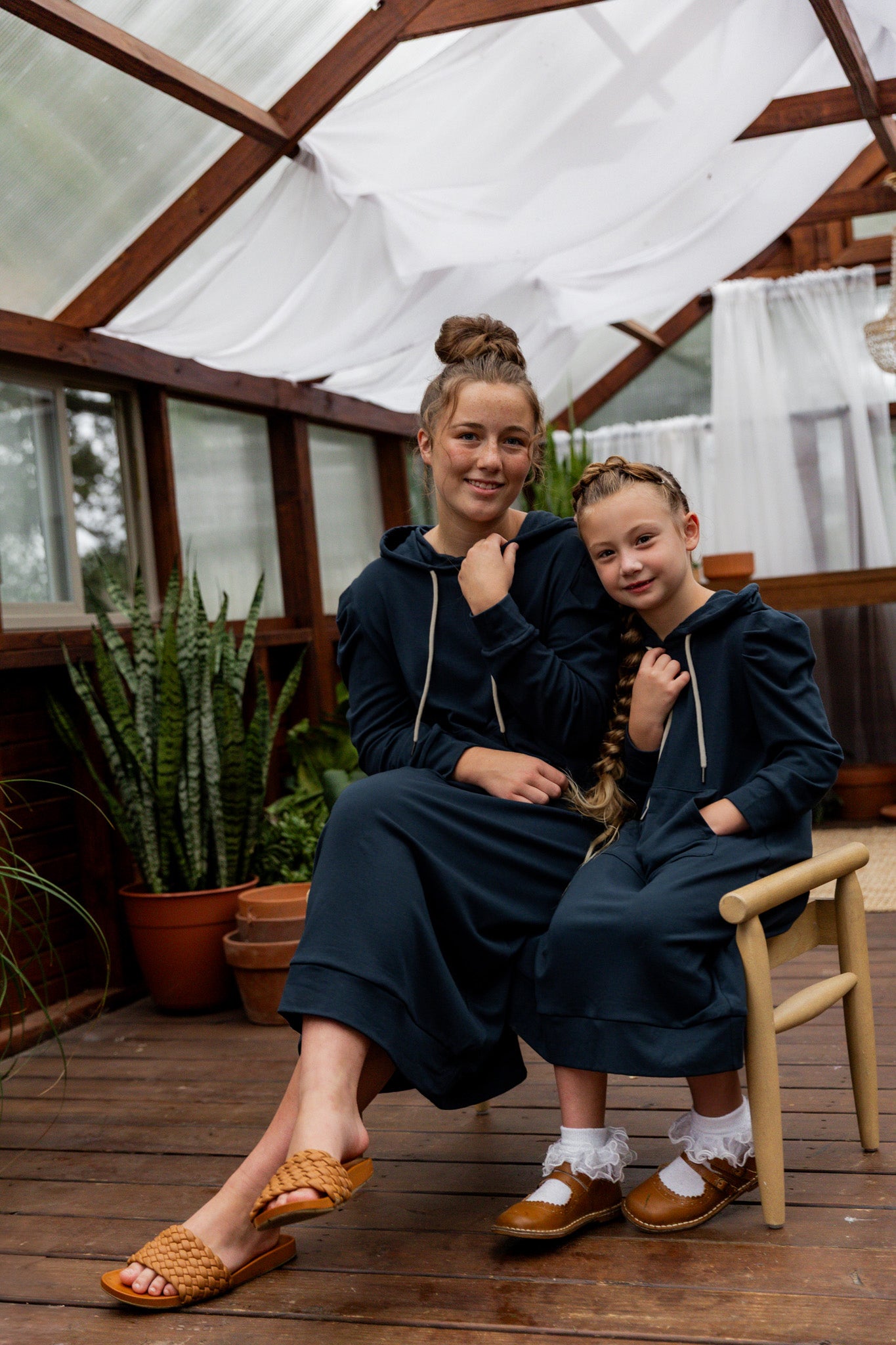 Model wearing Nuggles® Zoelle Dress in solid color, modest hoodie dress with puff sleeves.