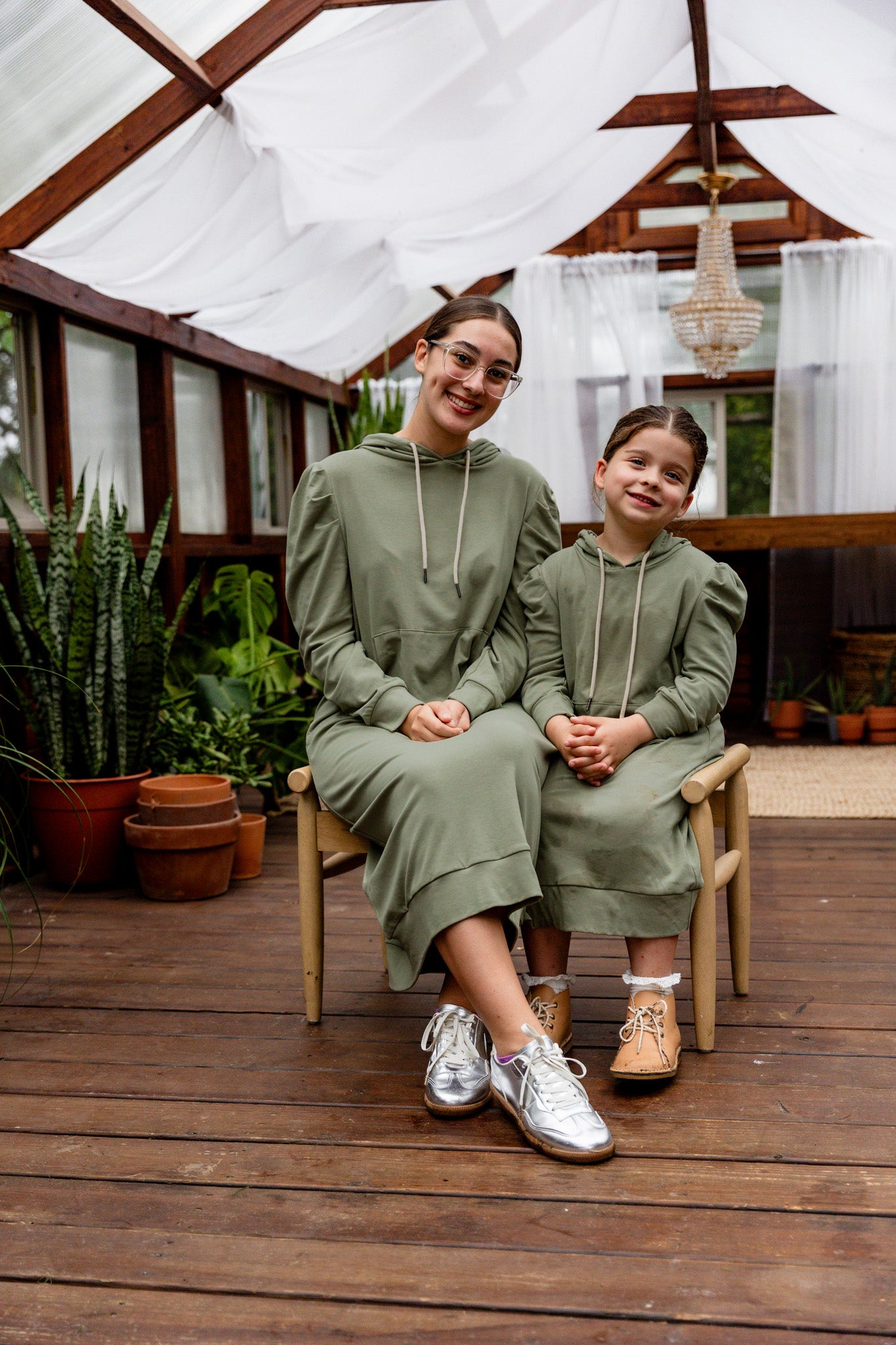 Model wearing Nuggles® Zoelle Dress in solid color, modest hoodie dress with puff sleeves.