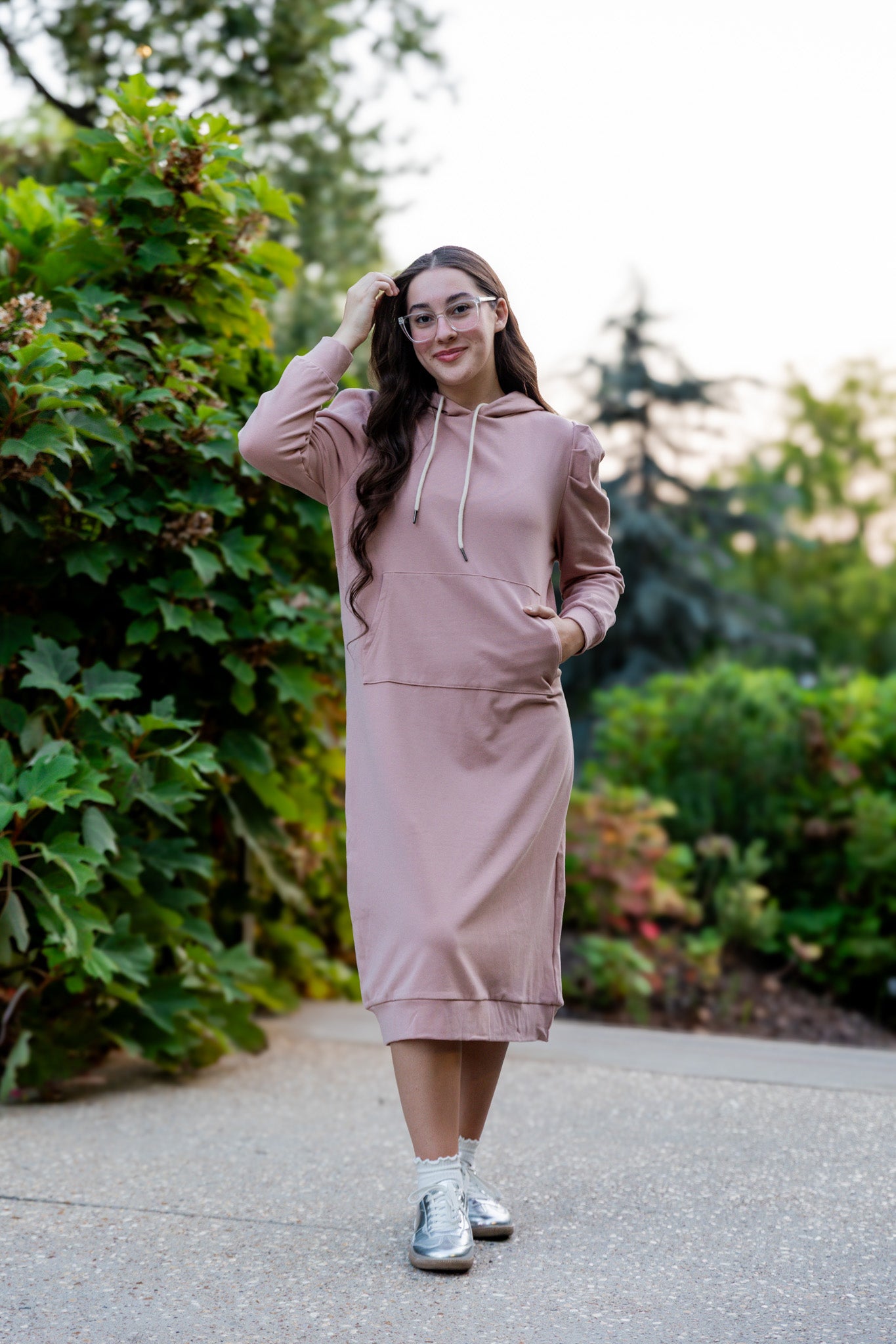 Model wearing Nuggles® Zoelle Dress in solid color, modest hoodie dress with puff sleeves.