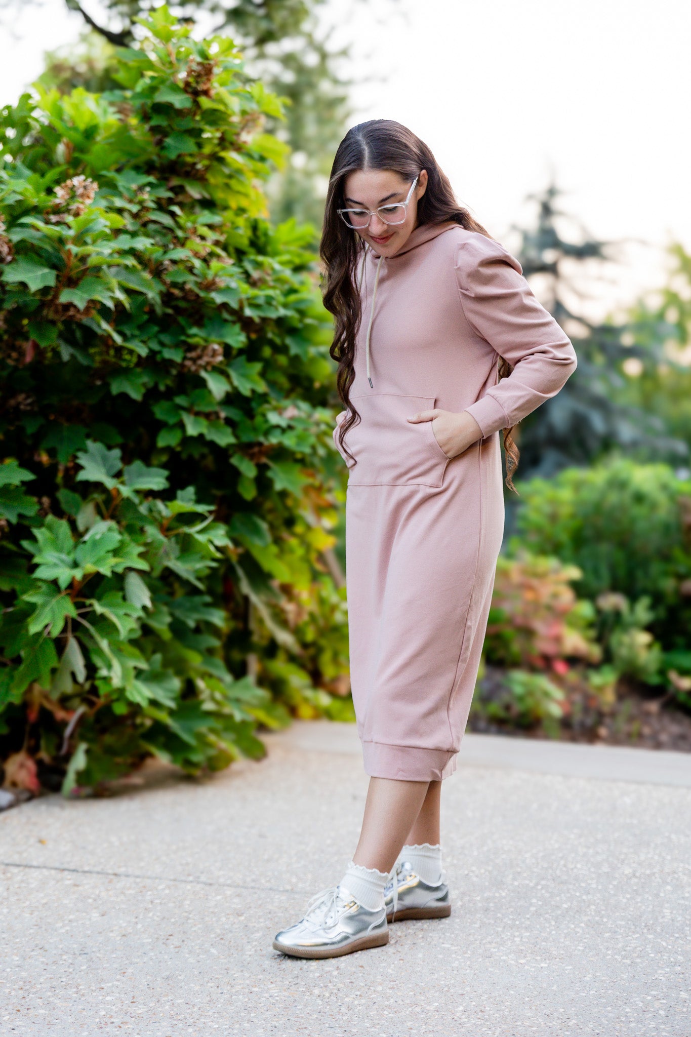 Model wearing Nuggles® Zoelle Dress in solid color, modest hoodie dress with puff sleeves.