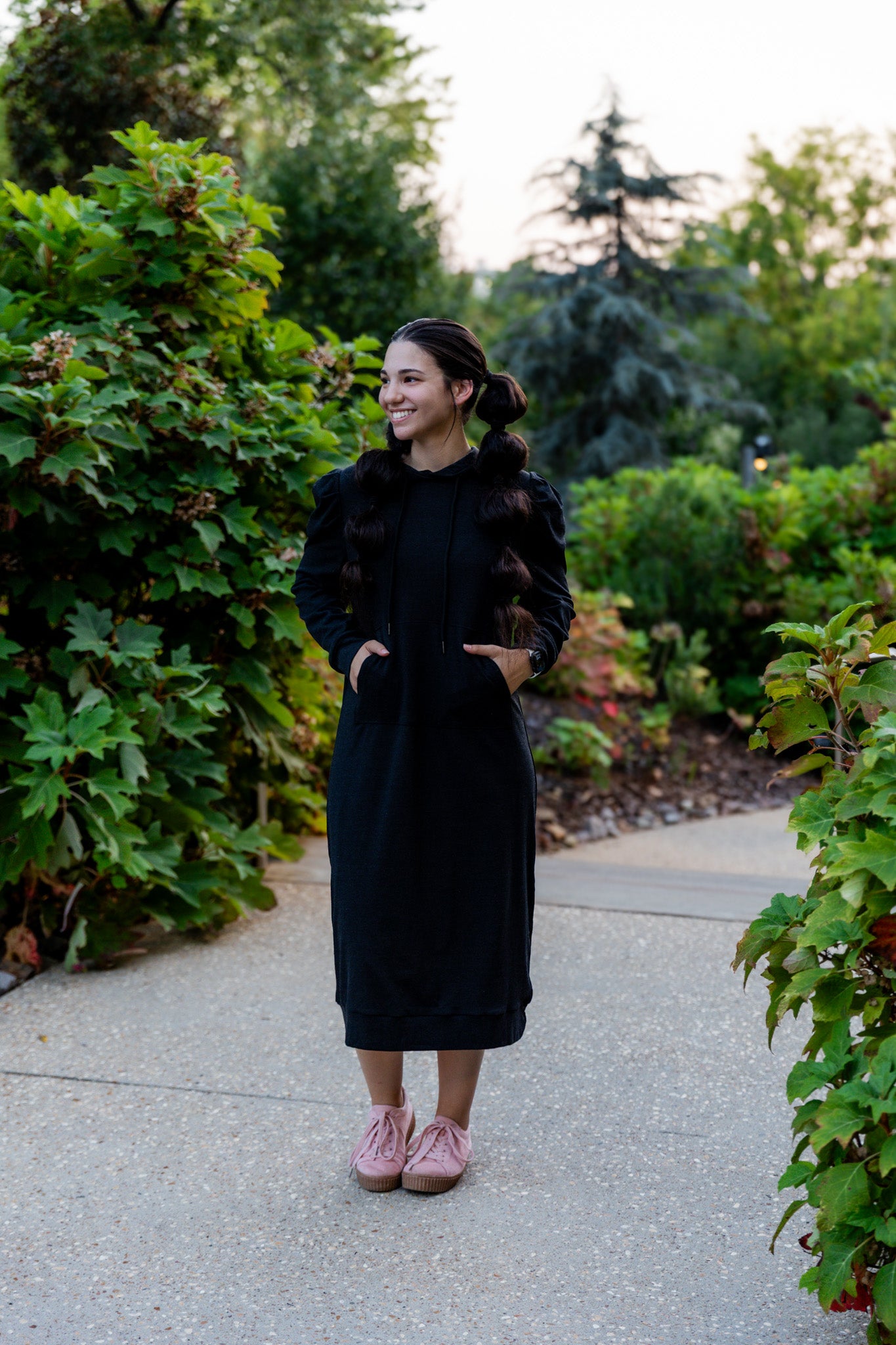 Model wearing Nuggles® Zoelle Dress in solid color, modest hoodie dress with puff sleeves.