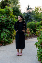 Model wearing Nuggles® Zoelle Dress in solid color, modest hoodie dress with puff sleeves.
