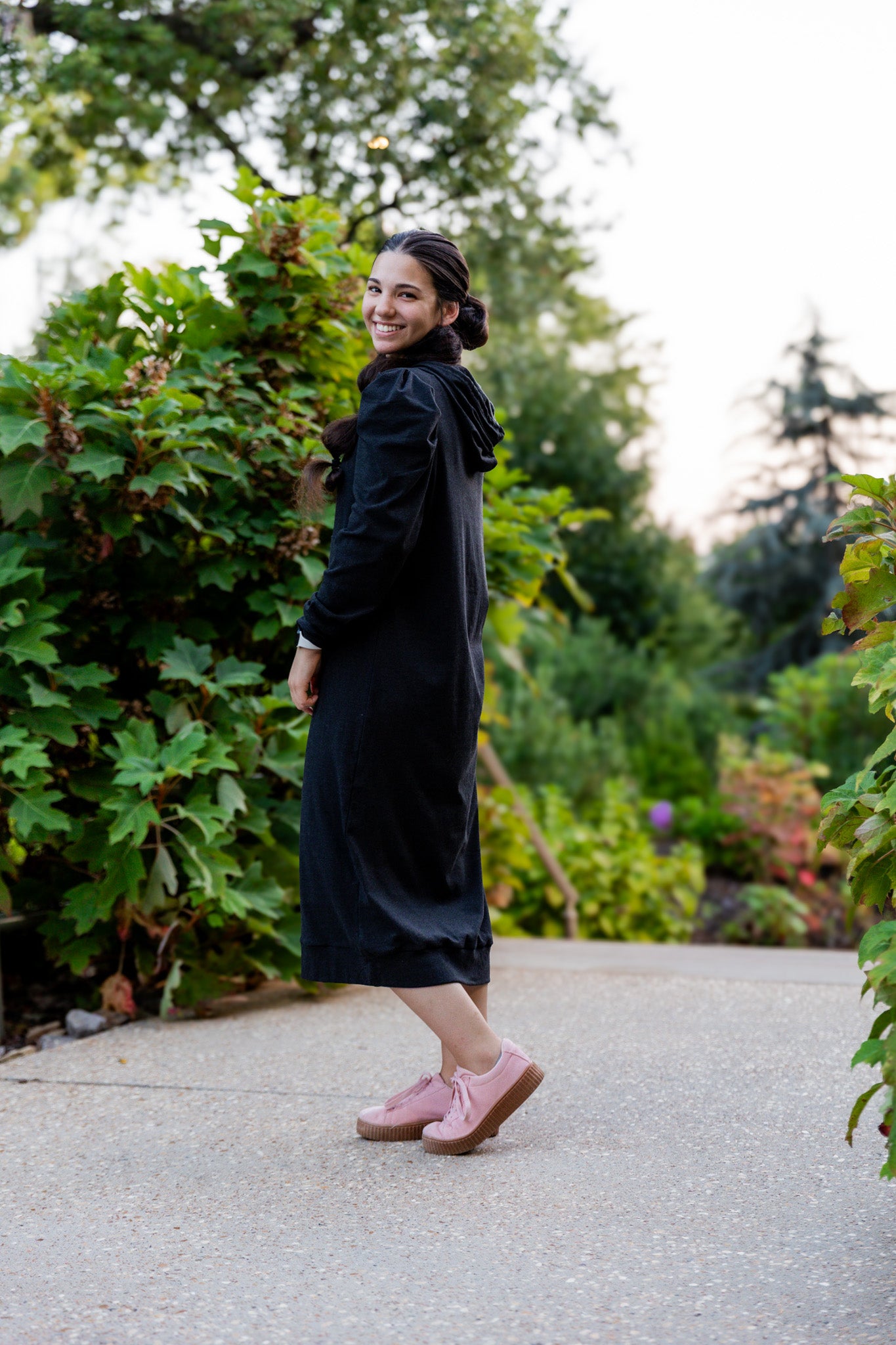 Model wearing Nuggles® Zoelle Dress in solid color, modest hoodie dress with puff sleeves.