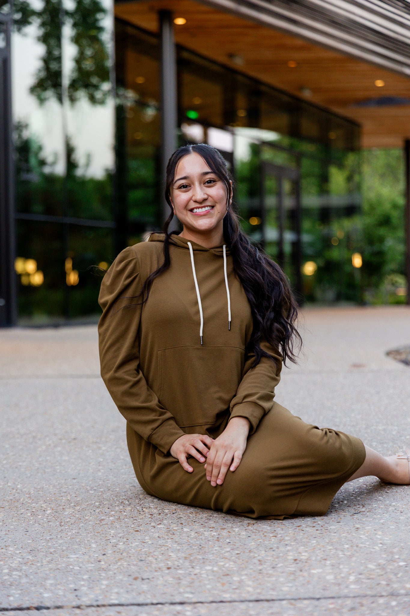 Model wearing Nuggles® Zoelle Dress in solid color, modest hoodie dress with puff sleeves.