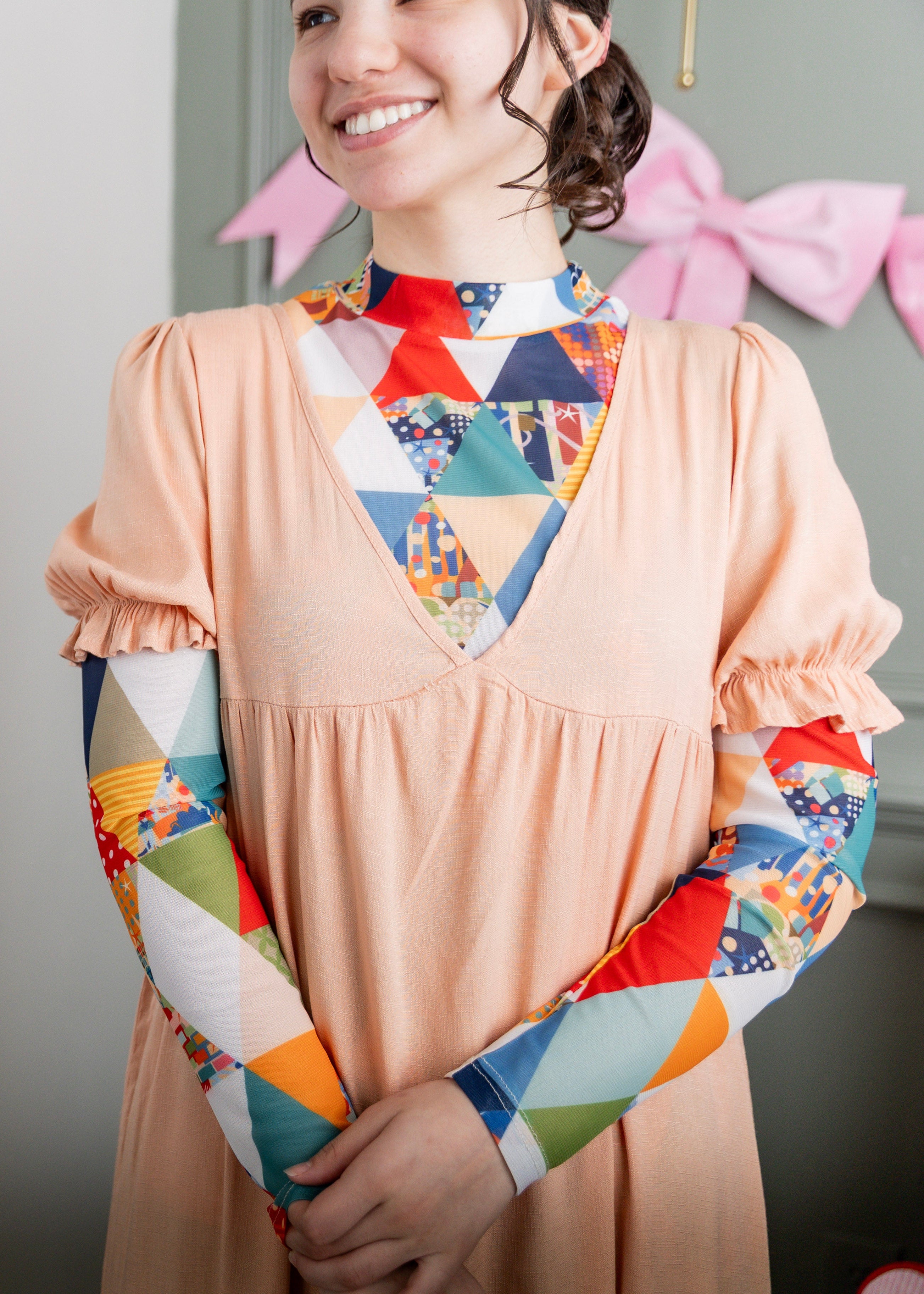 Model wearing Nuggles® Mesh Tee top in Triangle Taffy