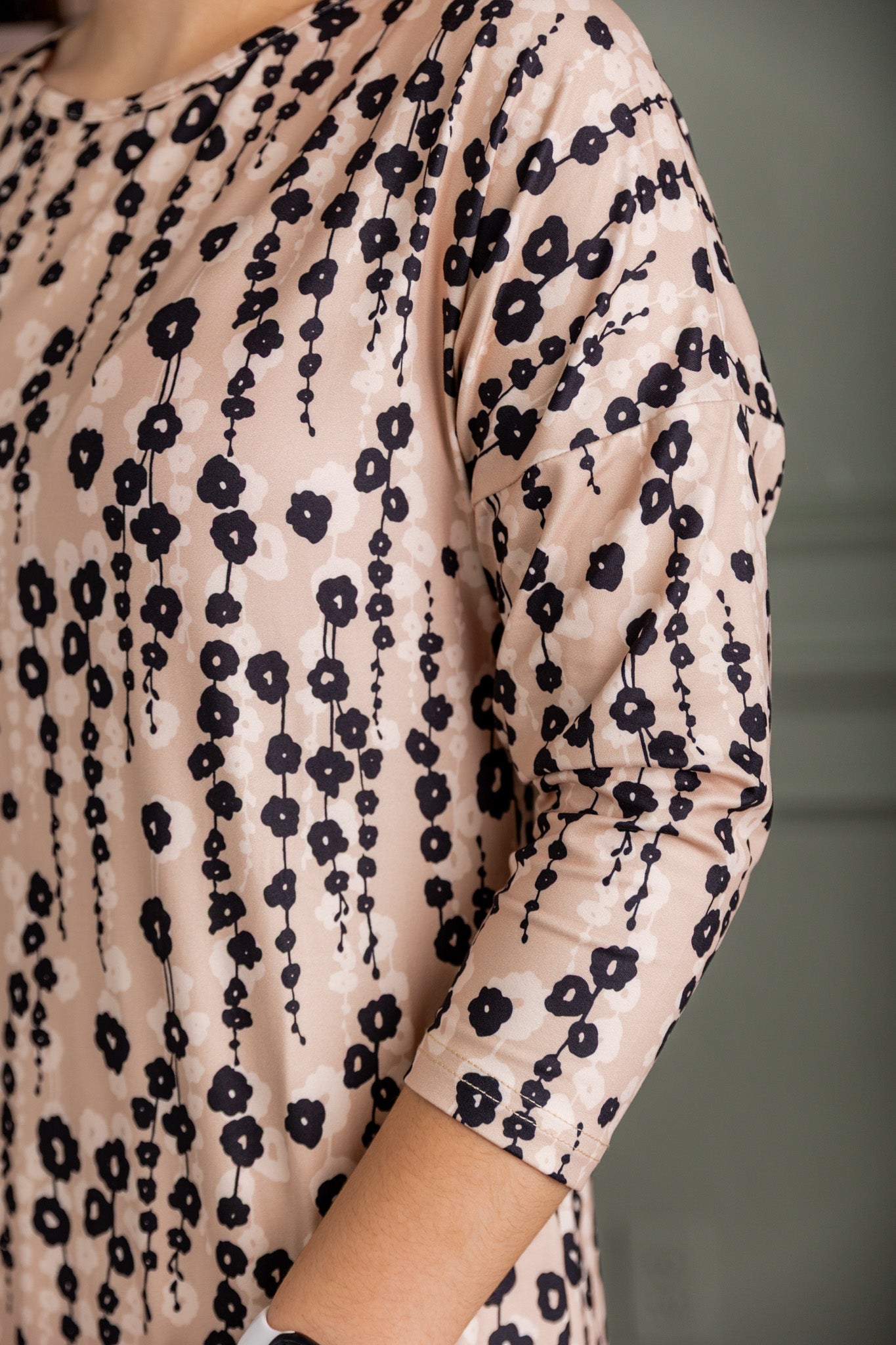 Model wearing Nuggles® Kate Dress in printed fabric, modest midi length with three-quarter sleeves.