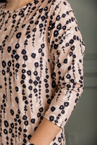 Model wearing Nuggles® Kate Dress in printed fabric, modest midi length with three-quarter sleeves.