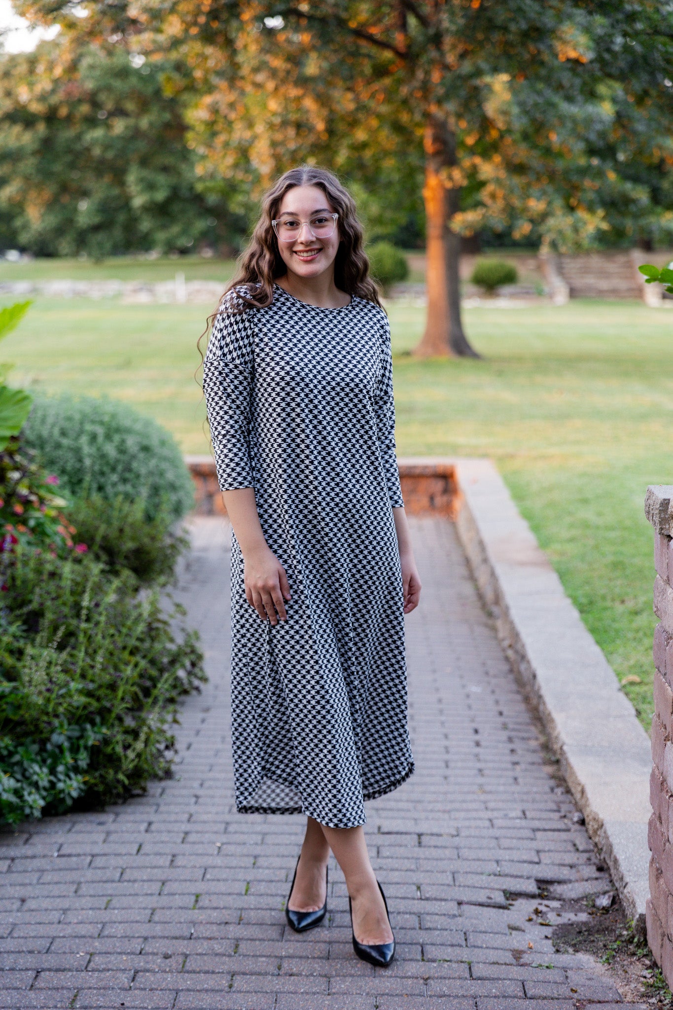 Model wearing Nuggles® Kate Dress in printed fabric, modest midi length with three-quarter sleeves.
