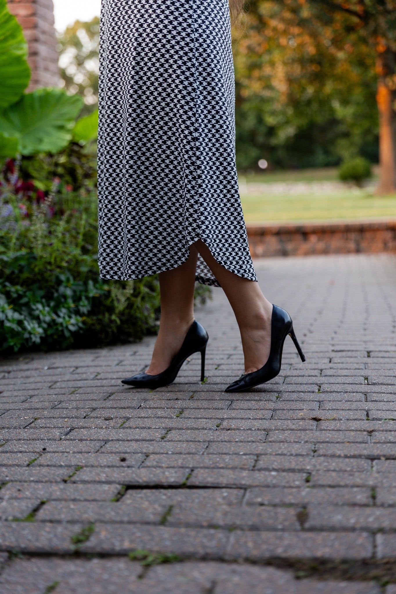 Model wearing Nuggles® Kate Dress in printed fabric, modest midi length with three-quarter sleeves.