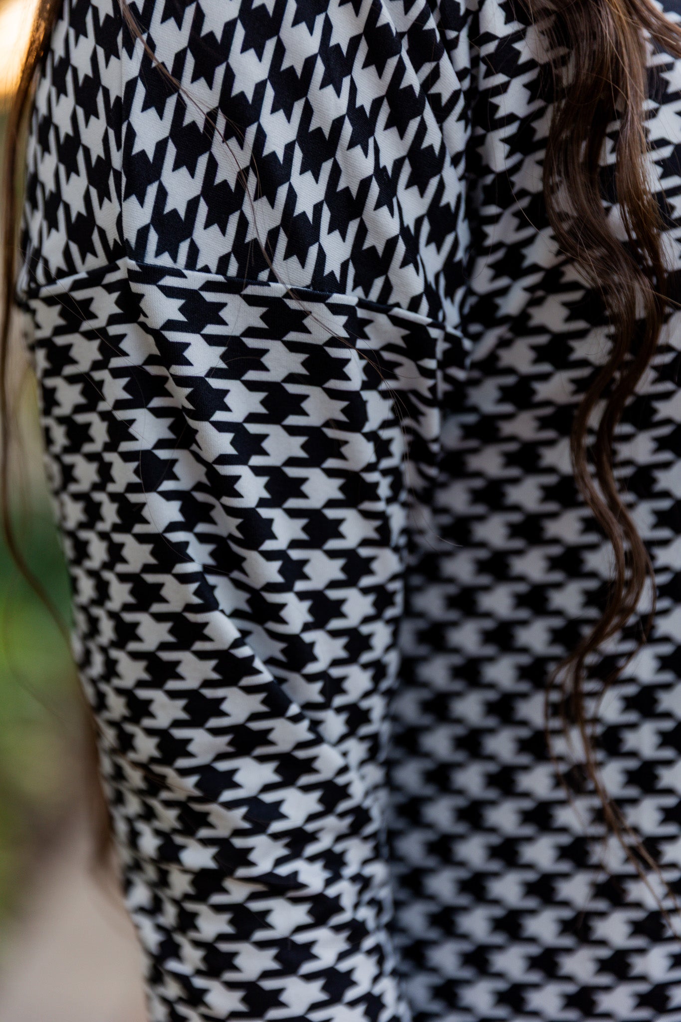 Model wearing Nuggles® Kate Dress in printed fabric, modest midi length with three-quarter sleeves.