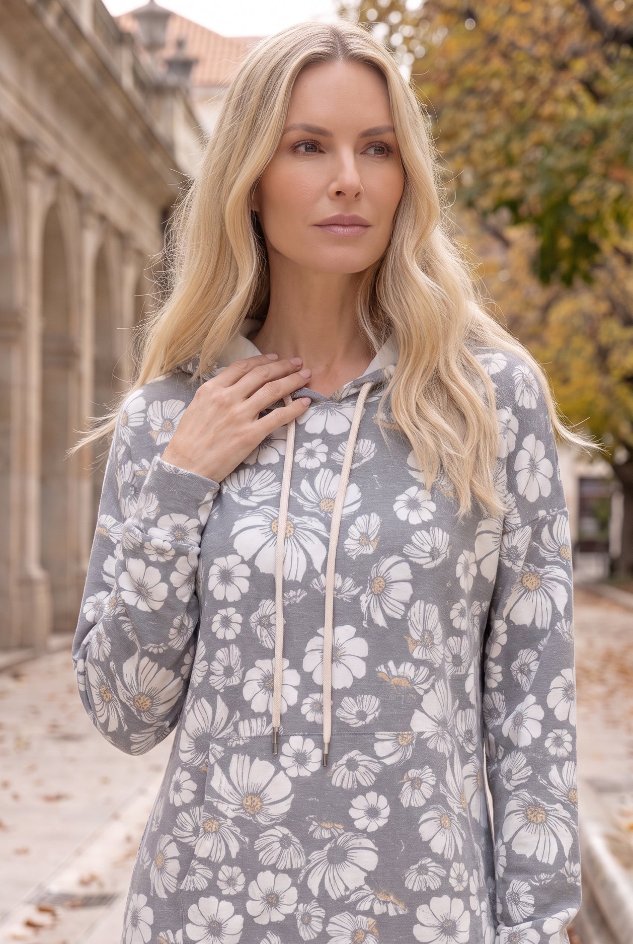 Nuggles® Hoodie Dress in Daisy Moon, chest-up crop showing the cream drawstring and hood lining