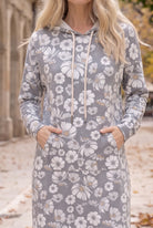 Nuggles® Hoodie Dress in Daisy Moon, both hands tucked into the front kangaroo pocket