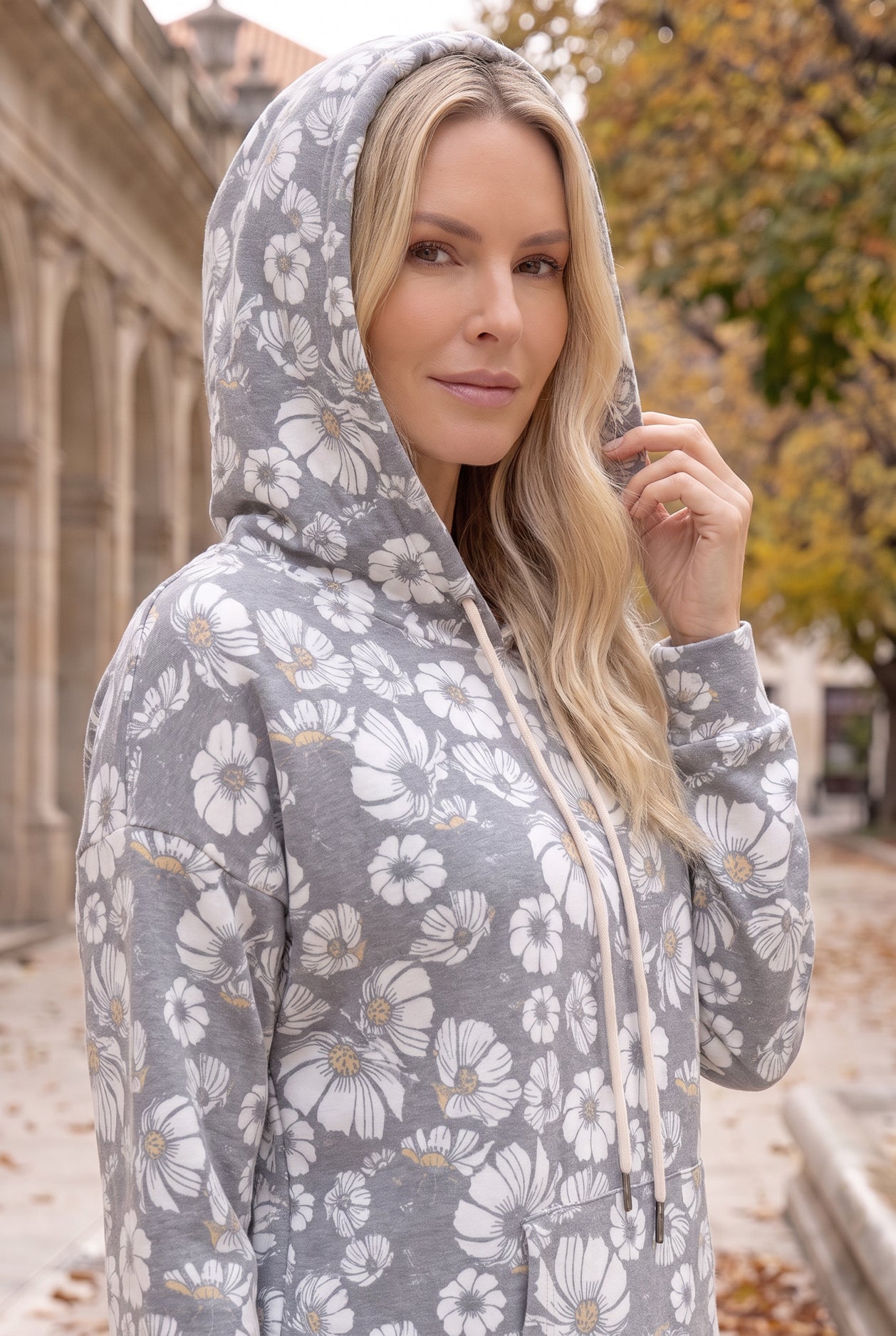Nuggles® Hoodie Dress in Daisy Moon worn with the hood up, showing the sleeve and daisy print scale