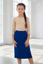 Model wearing the Nuggles® Girls' Classic Midi Skirt in Dark Royal Blue