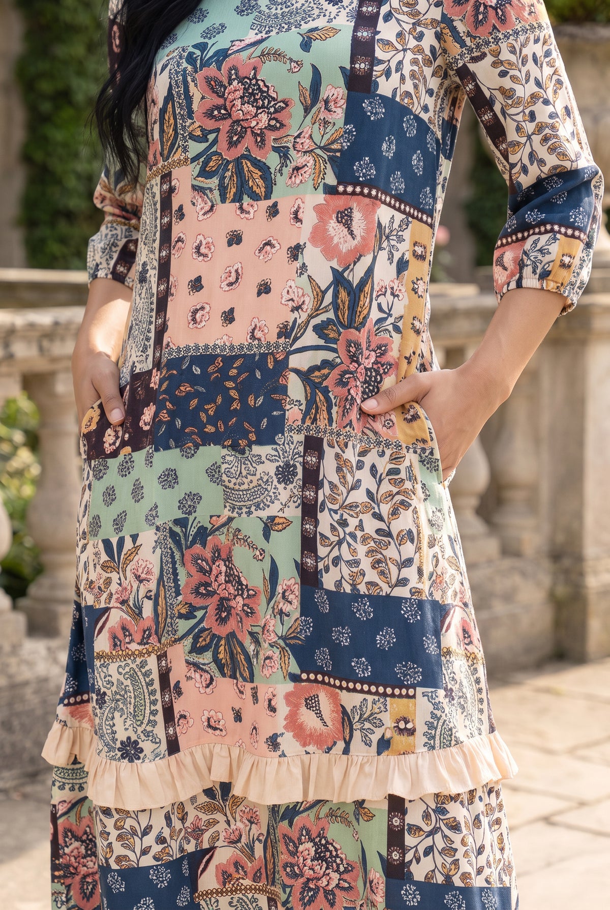 Nuggles® Patricia Dress in English Garden, waist-level crop with both hands in the side seam pockets