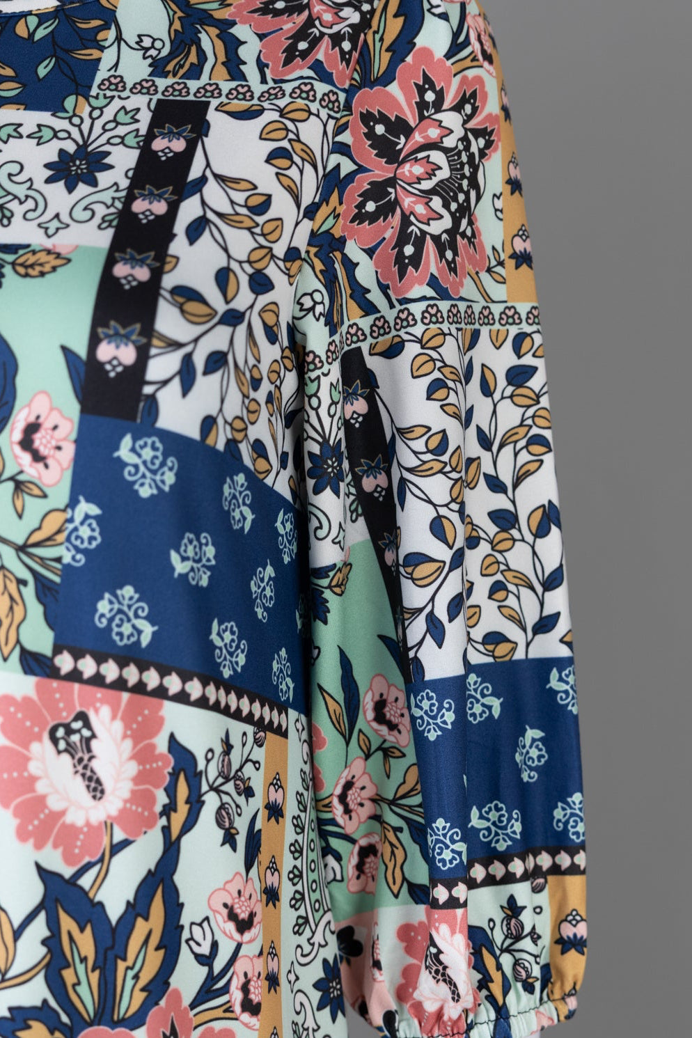 Nuggles® Patricia Dress in English Garden, detail of the patchwork print in sage, cream, pink and navy