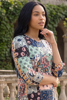 Nuggles® Patricia Dress in English Garden, upper body turned to the side showing the bodice print and 3/4 sleeve