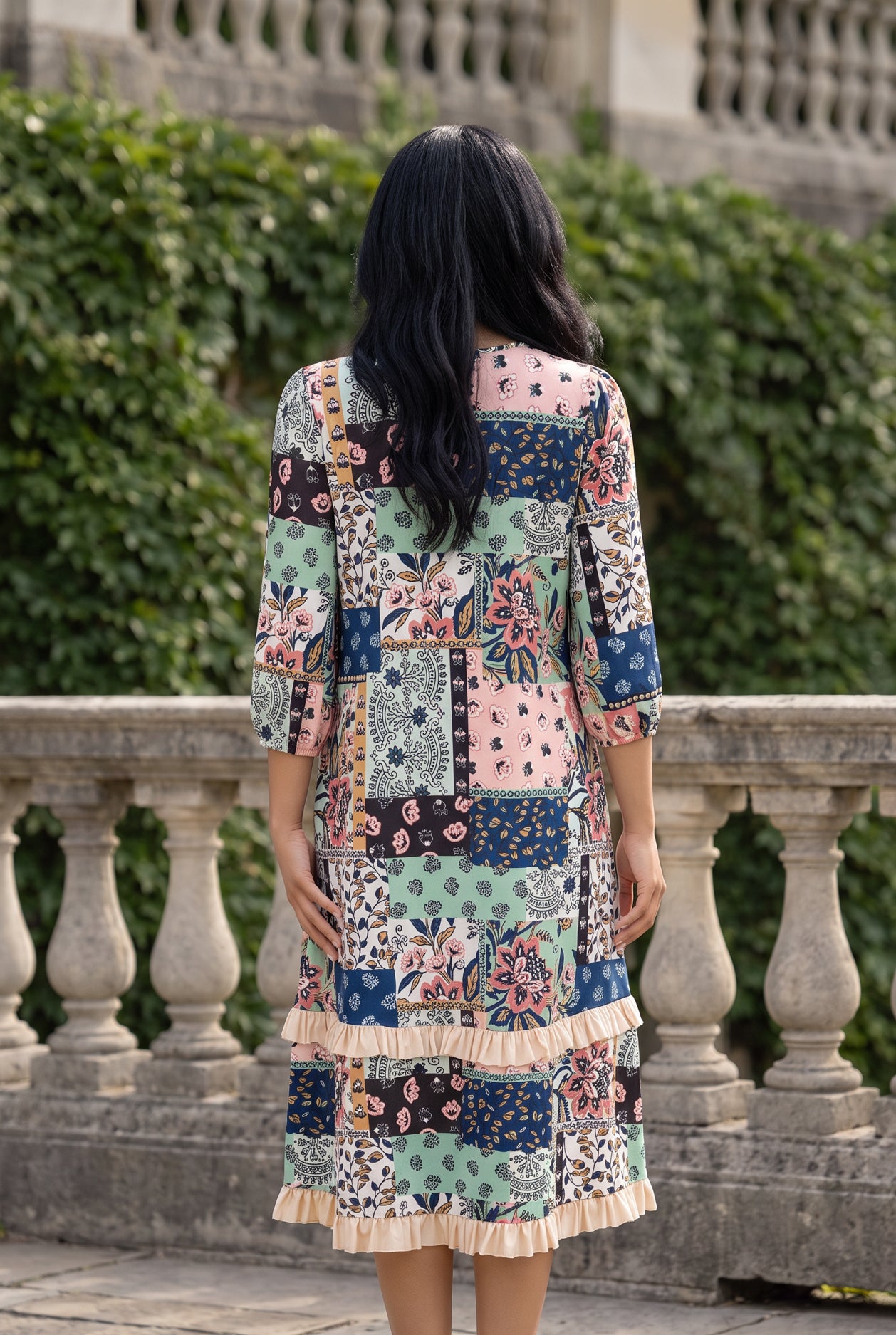 Nuggles® Patricia Dress in English Garden, full-length back view showing the relaxed fit and cream ruffle hem tiers
