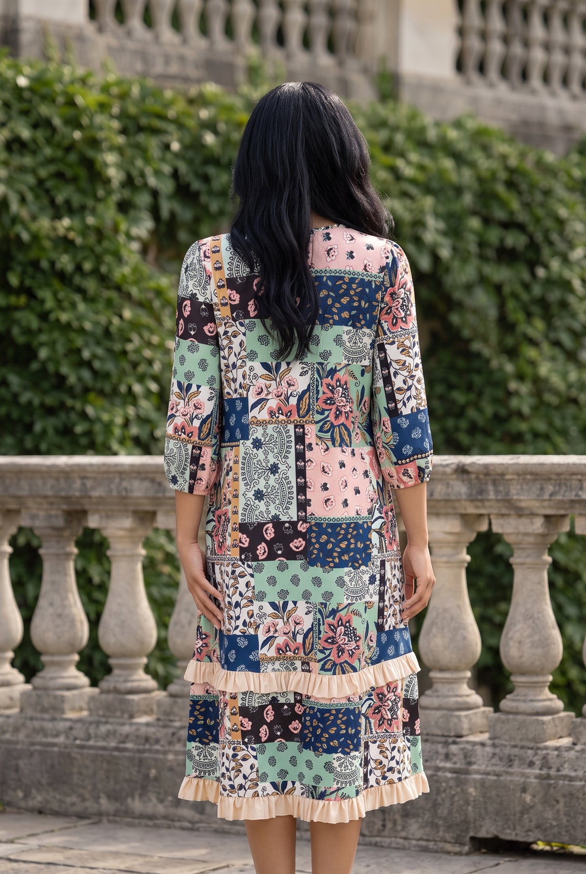 Nuggles® Patricia Dress in English Garden, full-length back view showing the relaxed fit and cream ruffle hem tiers