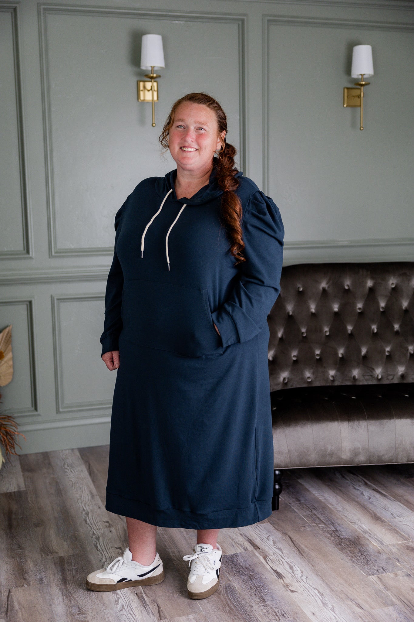 Model wearing Nuggles® Zoelle Dress in solid color, modest hoodie dress with puff sleeves.